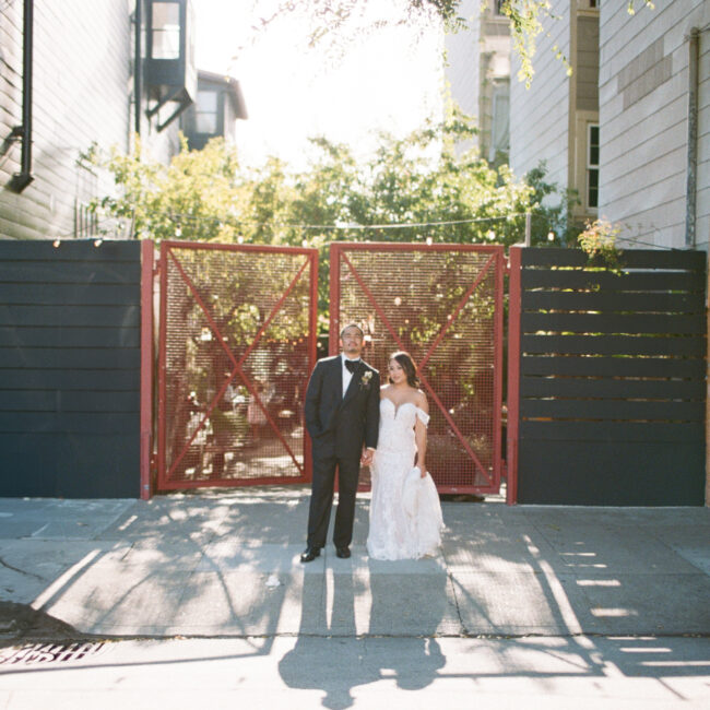 A beautiful photo of a bride and groom in front of their wedding venue, Stable Cafe.