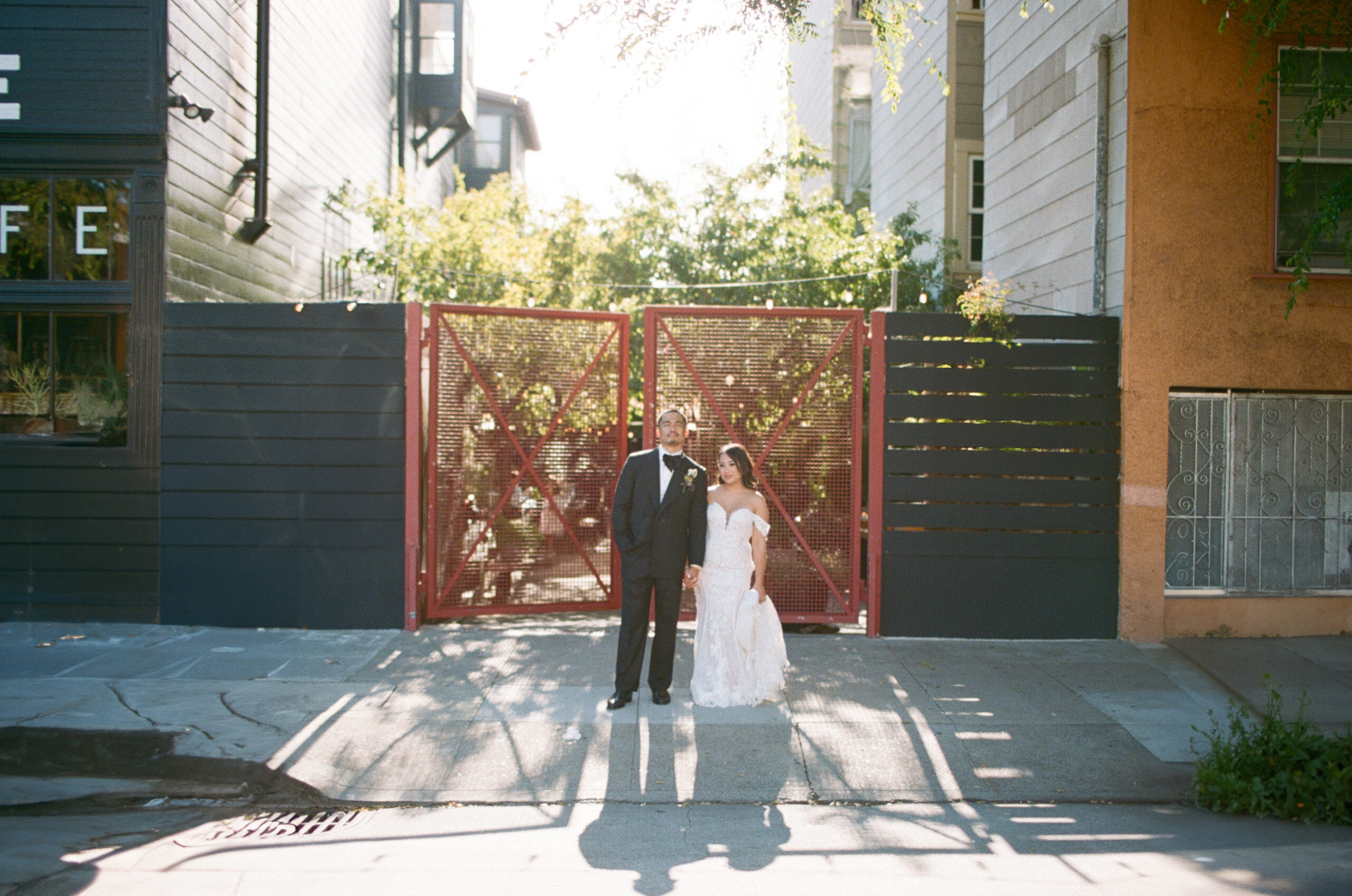 A beautiful photo of a bride and groom in front of their wedding venue, Stable Cafe.