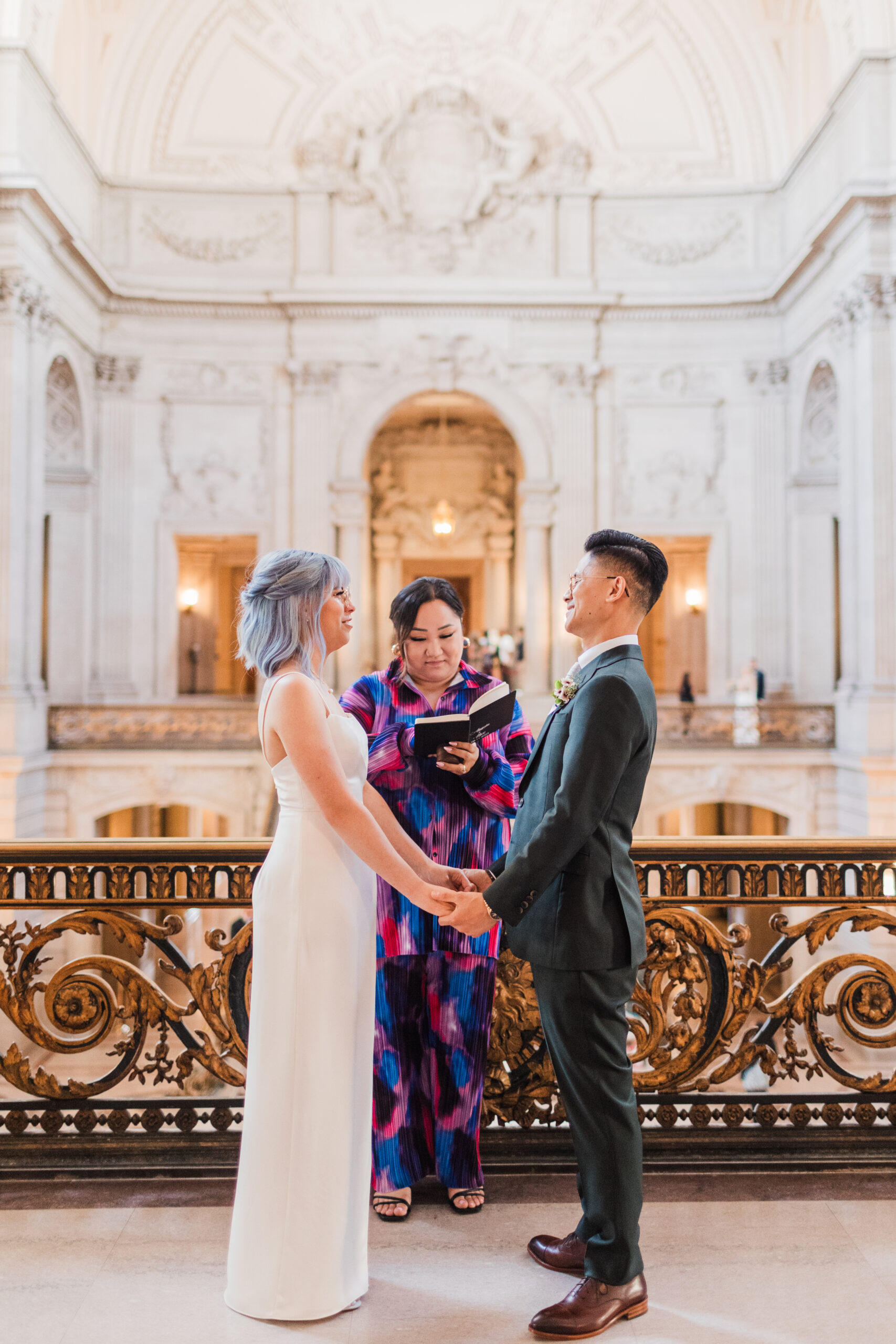 A picture of a couple getting married at the Mayor's Balcony at City Hall in San Francisco