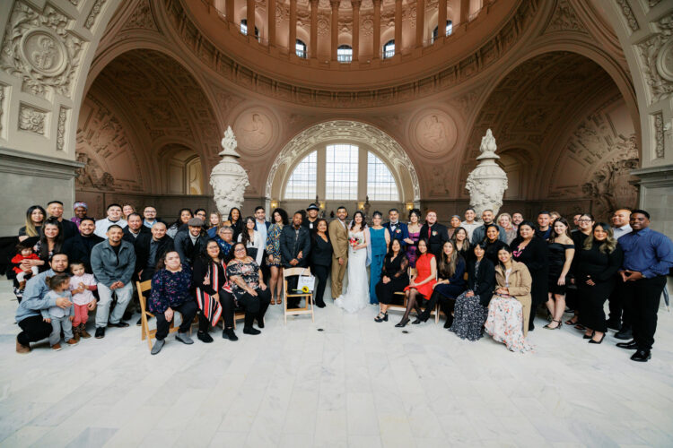 A family picture on the city hall 4th floor captured by a San Francisco City Hall wedding photographer