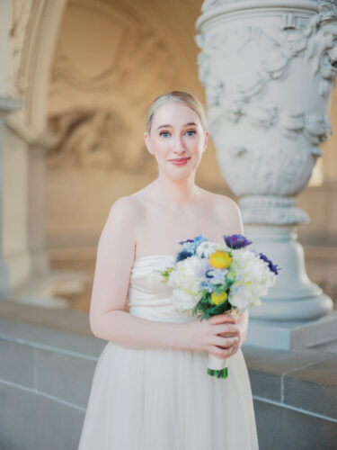 A bride poses after her City Hall wedding in San Francisco