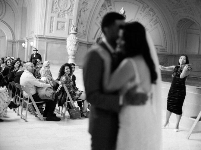 A couple does their first dance after their 4th floor city hall wedding